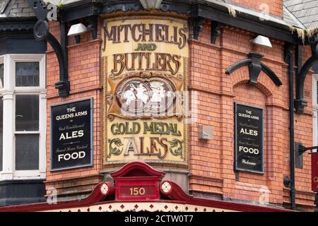 The ornate signage on the corner of the Queens Arms public House in Newhall Street Birmingham. The pub was once owned by Mitchells and Butlers a major brewer in the Midlands. Stock Photo