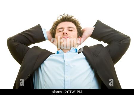 Young man in a suit relaxed hands behind his head Stock Photo