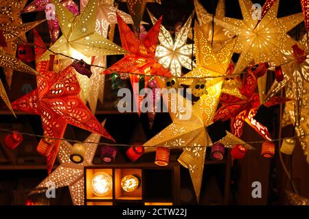 Colorful Illuminated Christmas Stars For Sale At Market. Traditional germany decoration. Stock Photo