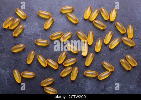 Capsules Omega 3 on dark stone background Close up Top view Health care concept Stock Photo