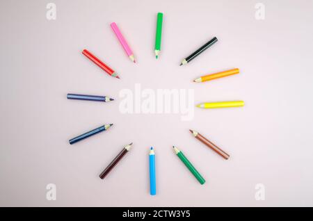 Bright beautiful pencils, 12 pieces. Colored pencils laid out in a circle on a white background close up, copy space Stock Photo