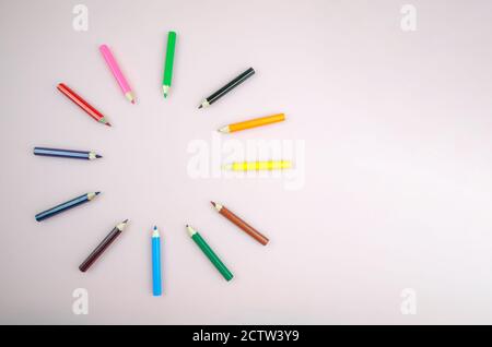 Bright beautiful pencils, 12 pieces. Colored pencils laid out in a circle on a white background close up, copy space Stock Photo