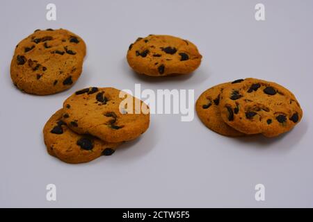 Very sweet shortbread cookie with chocolate pieces located on a white background. Ukrainian popular cookies, very satisfying with the taste of baked. Stock Photo