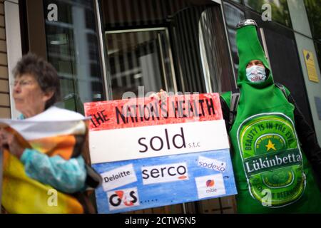 Campaigners outside the Department of Health and Social Care office in London protesting over Serco's handling of the test, track and trace system. Stock Photo