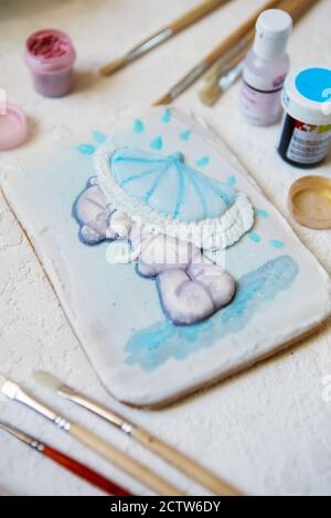 Painted gingerbread on a white background. Gingerbread in flat lay composition with food colors and brushes Stock Photo