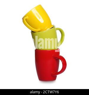 Stack of three motley cups isolated on white background. Three coffee mugs - red, green and yellow Stock Photo