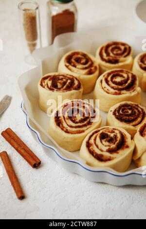Cinnabon buns. Raw Cinnamon rolls in a baking dish before baking Stock Photo
