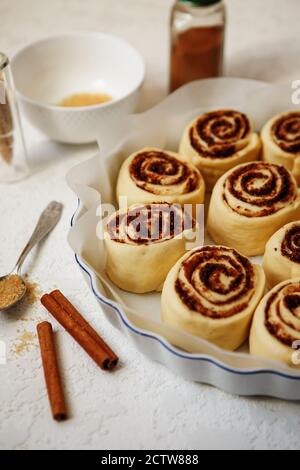Cinnabon buns. Raw Cinnamon rolls in a baking dish before baking Stock Photo
