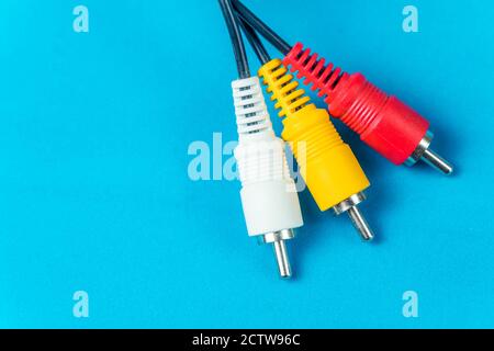 three audio-video plug cords on a blue background with copy space, macro photography Stock Photo
