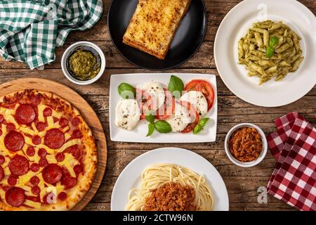 Assortment of Italian pasta dishes on wooden table Stock Photo