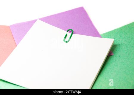 Red paper clip attached to multiple sheets of paper. Stock Photo