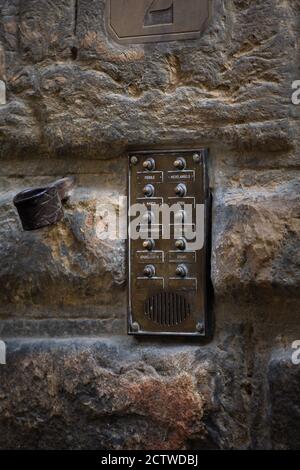 Vintage intercom at old stone building wall. Close up shot. May, 2013. Pisa, Ital Stock Photo