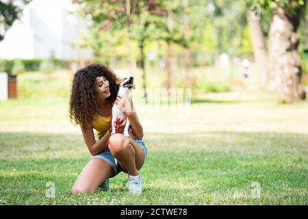 Selective focus of young woman holding jack russell terrier dog Stock Photo