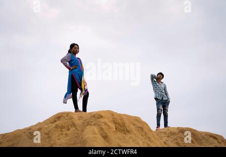 Young gypsies in traditional colorful clothes in the Thar desert at dawn on November 06, 2019 in Pushkar, Rajasthan, India. Stock Photo