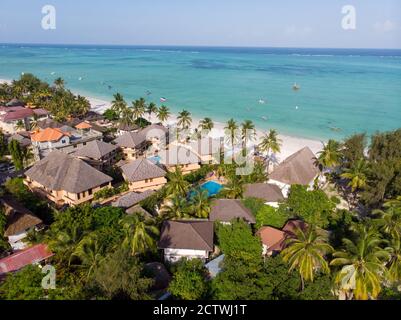 Aerial shot of a luxury hotel on a Beach first line with Palm Trees Garden at evening time in Paje village, Zanzibar, Tanzania Stock Photo