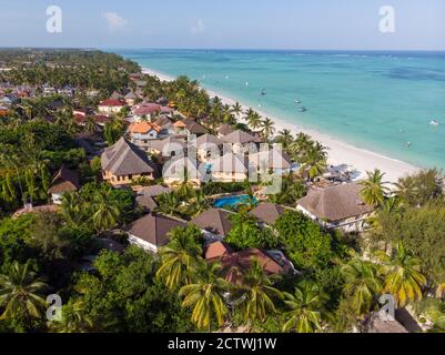 Aerial shot of a luxury hotel on a Beach first line with Palm Trees Garden at evening time in Paje village, Zanzibar, Tanzania Stock Photo