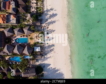 Aerial shot of a luxury hotel on a Beach first line with Palm Trees Garden at evening time in Paje village, Zanzibar, Tanzania Stock Photo