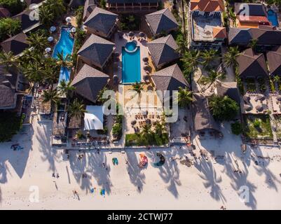 Aerial shot of a luxury hotel on a Beach first line with Palm Trees Garden at evening time in Paje village, Zanzibar, Tanzania Stock Photo