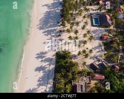 Aerial shot of a luxury hotel on a Beach first line with Palm Trees Garden at evening time in Paje village, Zanzibar, Tanzania Stock Photo