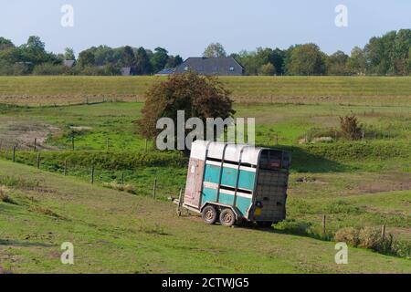 old horse trailer in a meadow Stock Photo