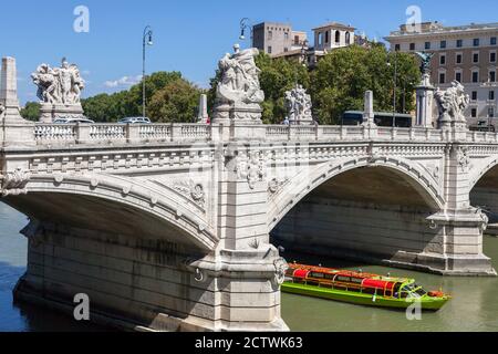 ROME, ITALY - 2014 AUGUST 18. Tourist boat passing the bridge at Tiber River. Stock Photo
