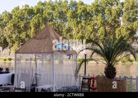 ROME, ITALY - 2014 AUGUST 19. Sitting chairs at Tiber river. Stock Photo