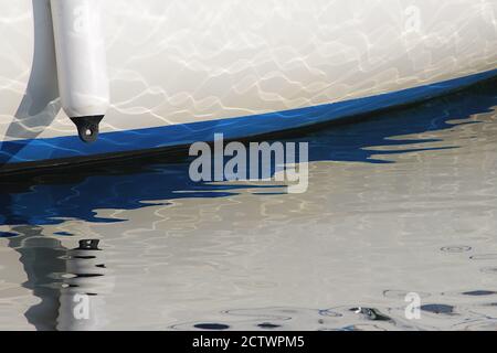 White and blue boat abstract reflections in the sunshine Stock Photo