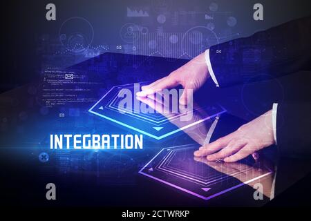 Hand touching digital table with INTEGRATION inscription, new age security concept Stock Photo