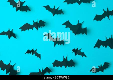 Halloween background. Black bats cut from paper on a blue background. Halloween decor and decorations for the holiday, copy space. Stock Photo
