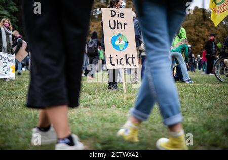 25 September 2020, Baden-Wuerttemberg, Stuttgart: ''The clock is ticking'' is written on the poster of a participant in the global climate strike of the climate protection movement Fridays for Future. The climate movement Fridays for Future has called for a worldwide day of action after months of protests mainly on the internet. Photo: Christoph Schmidt/dpa Stock Photo