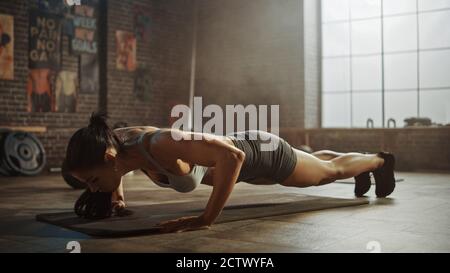 Strong and Fit Beautiful Busty Girl in an Athletic Top is Doing Crisscross  Crunch Workout in Her Bright and Spacious Living Room with Minimalistic  Stock Photo - Alamy