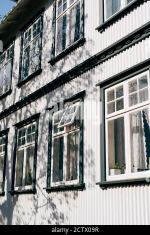 A two-storey building made of corrugated board in white with plastic windows. Stock Photo