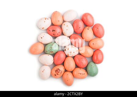 Pile of chocolate eggs candies isolated on white background. close up, top view, flat lay. Stock Photo