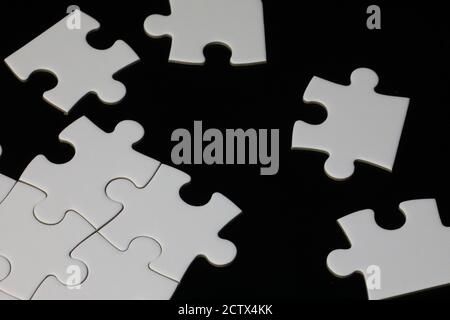 Jigsaw puzzle pieces on a black background Stock Photo