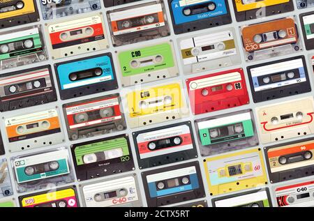 Large set of old vintage audio tape cassettes on gray background, colorful retro music background Stock Photo