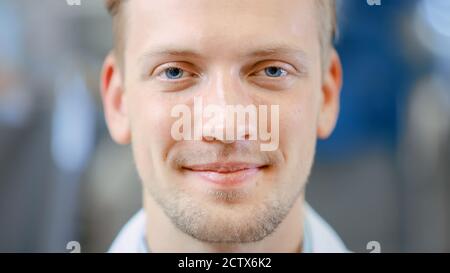 Close Up of a Handsome Young Blond Male Portrait Shot. He's a Professional Employee. Man Looks and Smiles at Camera. Expresses Success and Happiness Stock Photo