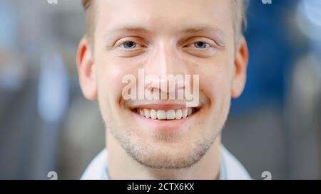 Close Up of a Handsome Young Blond Male Portrait Shot. He's a Professional Employee. Man Looks and Smiles at Camera. Expresses Success and Happiness Stock Photo
