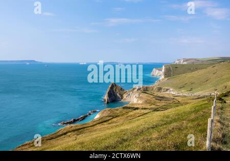 Panoramic coastal clifftop view from the South West Coast Path from Lulworth Cove to Durdle Door on the Jurassic Coast World Heritage site in Dorset