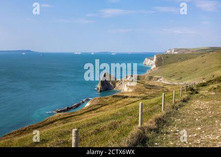 Panoramic coastal clifftop view from the South West Coast Path from Lulworth Cove to Durdle Door on the Jurassic Coast World Heritage site in Dorset Stock Photo