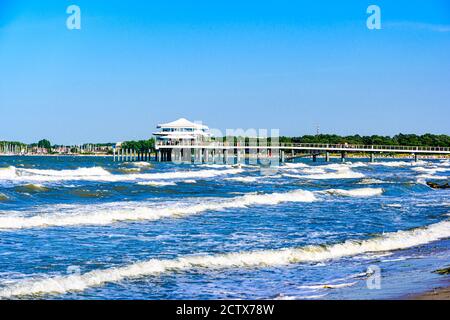 Beach, house with a footbridge in Timmendorfer Strand nearby Lubeck - Travemunde (Travemünde) on baltic sea with waves.  Schleswig-Holstein, Germany Stock Photo