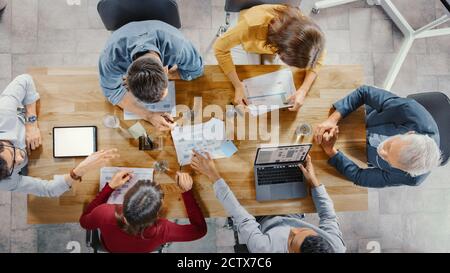 Diverse Group of Specialists and Employees Deliver Reports to Executive Director, Show Documents, Graphs and Statistics. Company CEO Making Speech Stock Photo