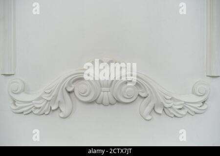 Vintage Stucco elements on light luxury wall. White patterned. Moulding element from gypsum. Close up shot. High quality photo. Stock Photo