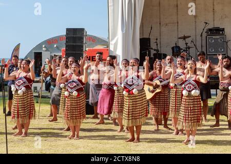 New Zealand Maori men and women in traditional dress performing a haka