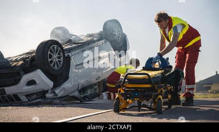 Paramedics and Firefighters Arrive On the Car Crash Traffic Accident Scene. Professionals Prepairing Stretchers For Rescue Injured Victim Trapped in Stock Photo