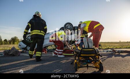 Paramedics and doctor rushing with victim patient on ambulance ...