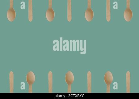 Wooden spoon utensils frame. Plastic free, eco friendly disposable cutlery. Flat lay, seamless pattern with copy space. Stock Photo
