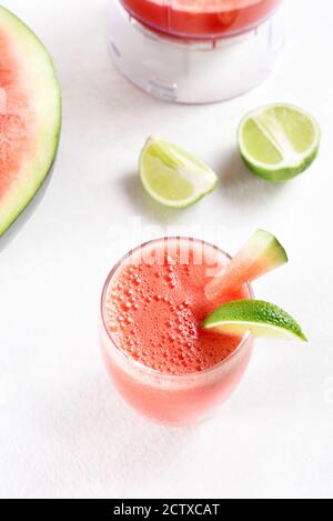 Watermelon lime juice in a glass on white stone backgrond. Healthy summer drink. Stock Photo