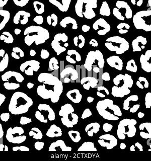 Leopard skin white and black seamless pattern. Hand drawn animal fur skin texture. White spots ornament on black background. Print for textile, wallpa Stock Photo