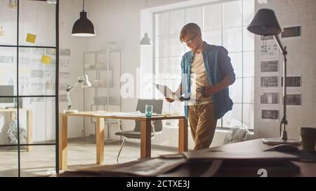 Young Creative Developer is Working in His Studio on a Laptop. Concept of Sucessful Designer working on Application Design, Software UI Development Stock Photo