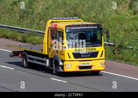 2016 yellow Man TGL Egertons Breakdon Recovery lorry;  Haulage delivery trucks, lorry, transportation, truck, MAN vehicle, delivery, commercial transport industry on the M6 at Lancaster, UK Stock Photo